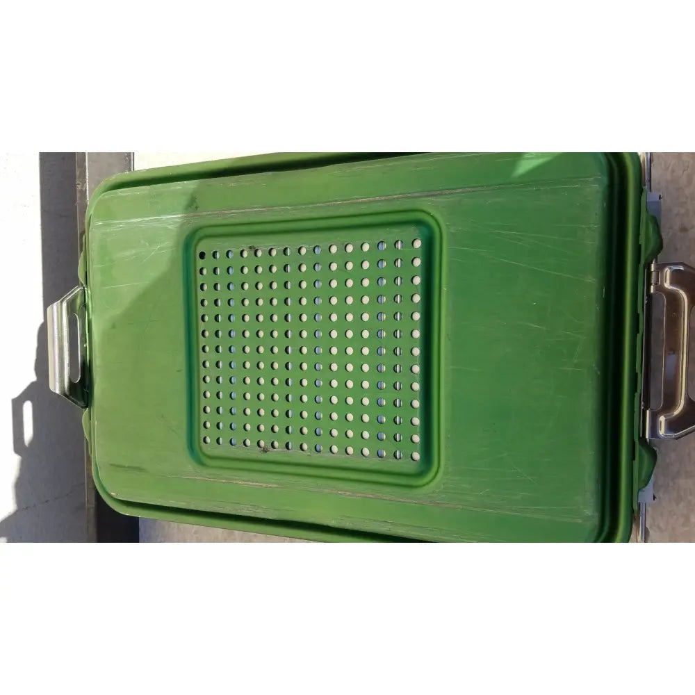 Green plastic genesis carefusion sterilization container with perforated lid and metal latches for secure sterilization