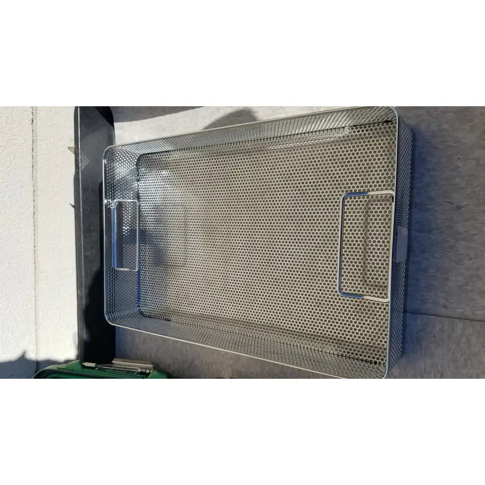Rectangular stainless steel mesh tray with two side handles in genesis carefusion sterilization container cd2-5c