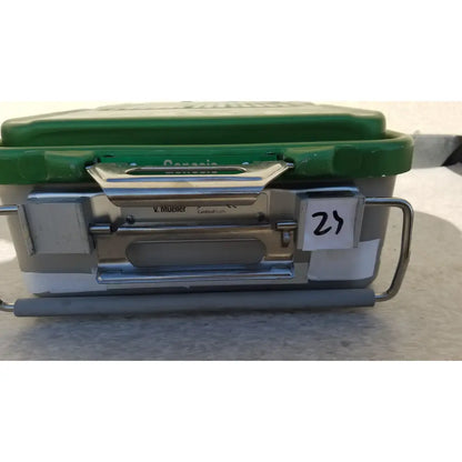 Green and silver genesis carefusion sterilization container with metal handle and labeled tag for dental instruments
