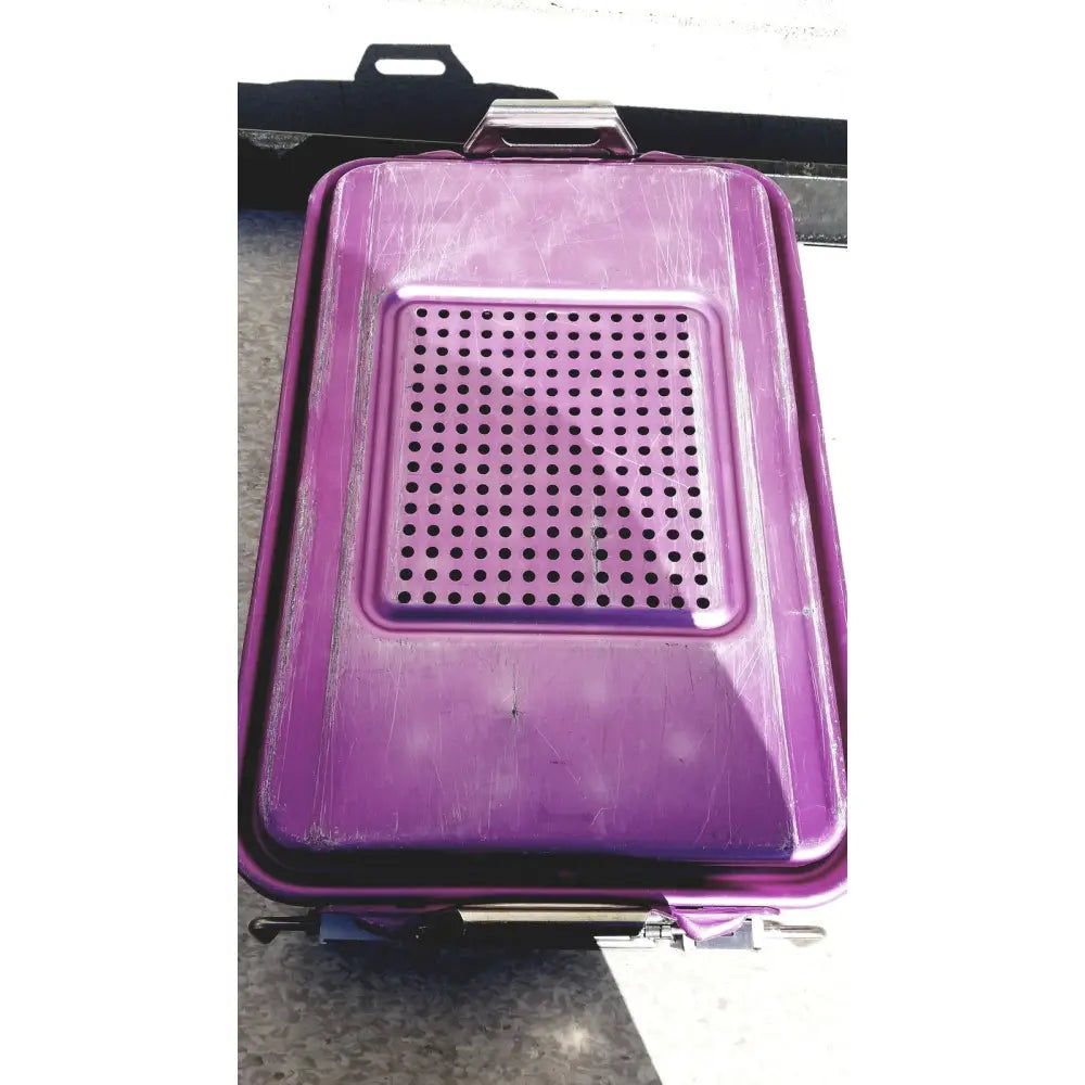 Purple plastic genesis carefusion sterilization container with perforated lid and metal handle 5 inches deep