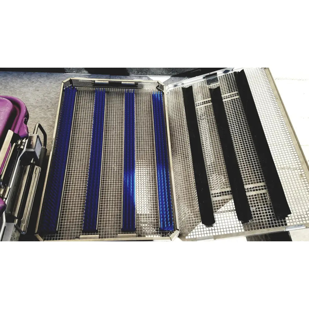 Metallic mesh tray with blue and black padded inserts in v.mueller genesis carefusion sterilization container 5 inch deep