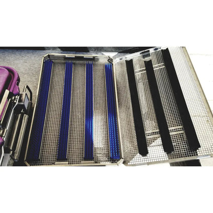 Metallic mesh tray with blue and black padded inserts in v.mueller genesis carefusion sterilization container 5 inch deep