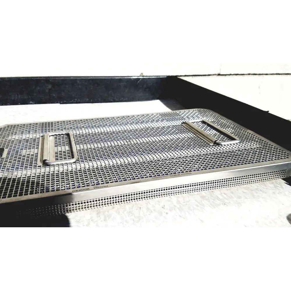 Silver stainless steel mesh surgical instrument tray with two rectangular handles in genesis carefusion sterilization container