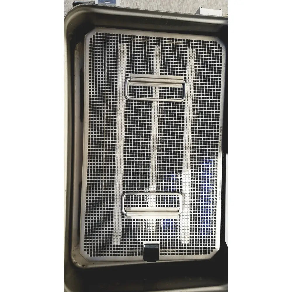 Stainless steel mesh tray with two rectangular handles and black latch in V.Mueller Genesis CareFusion sterilization container 5 inch deep