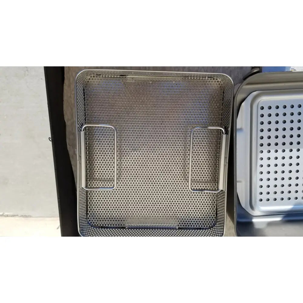 Stainless steel mesh deep fryer basket with two side handles in a genesis carefusion sterilization container system