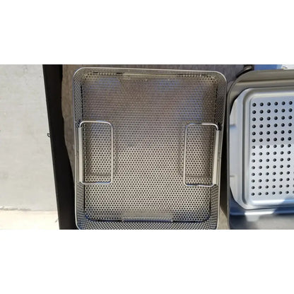Stainless steel mesh deep fryer basket with two side handles in a genesis carefusion sterilization container system