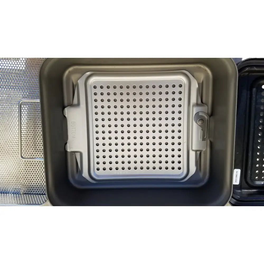 Silver perforated rectangular baking tray with rounded corners for genesis carefusion sterilization container use
