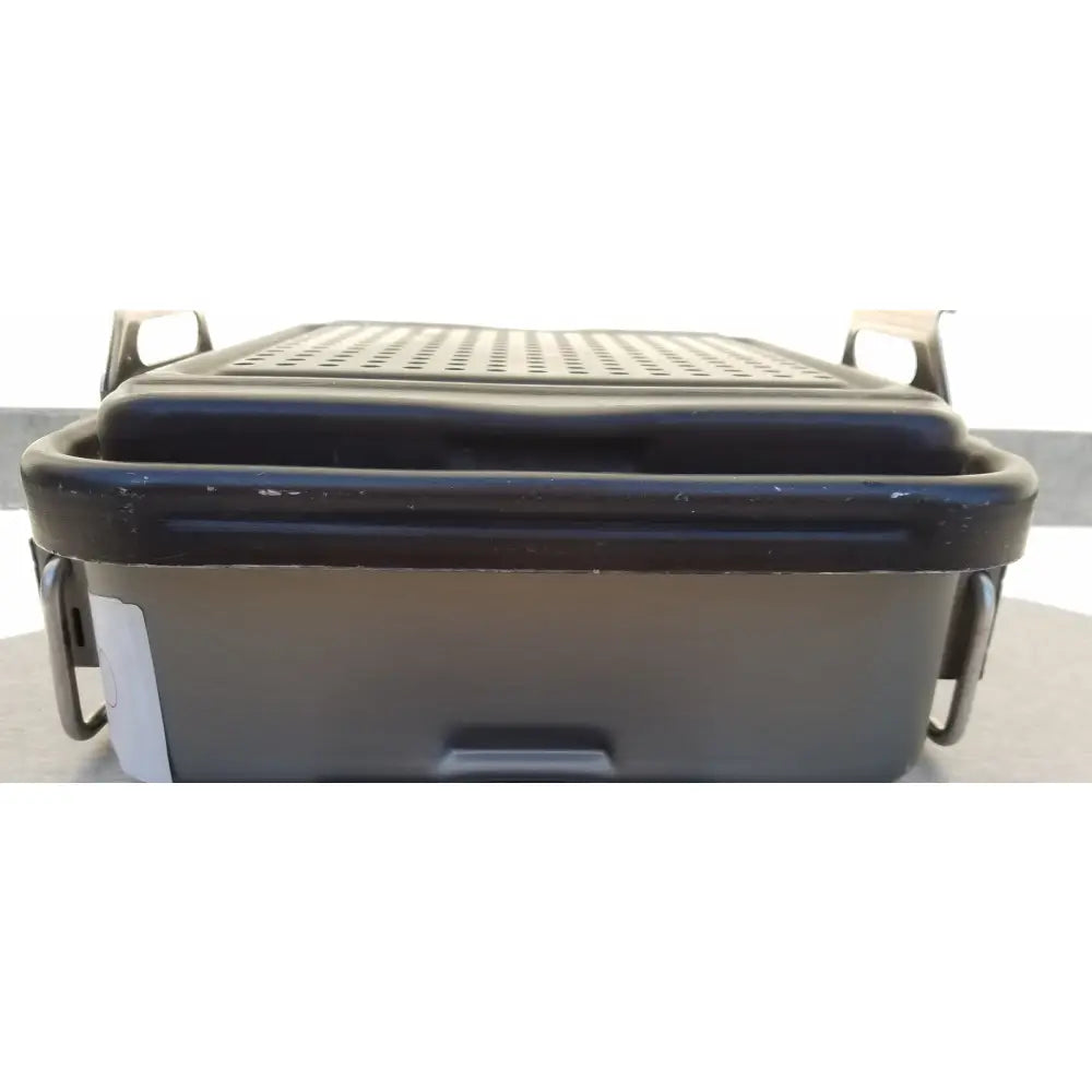 Black plastic genesis carefusion sterilization container with perforated lid and side handles for medical use