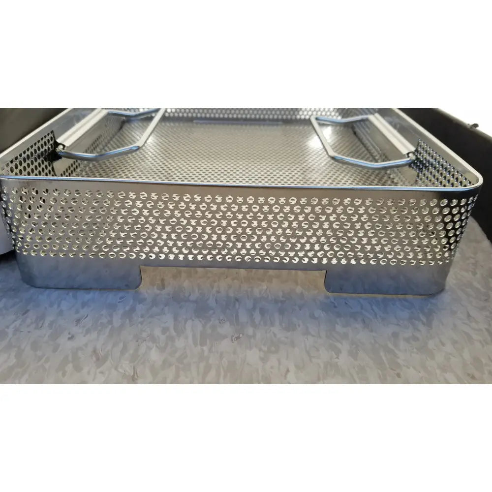 Silver perforated metal surgical instrument tray with reinforced handles and sturdy base for genesis carefusion sterilization container