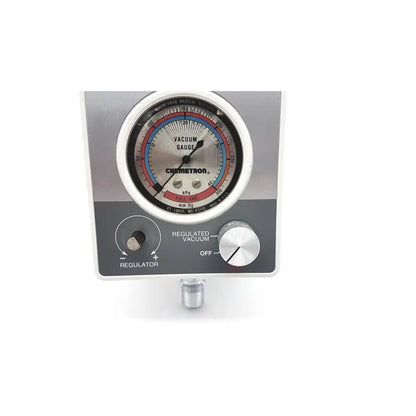 Silver and black chemetron vacuum gauge with circular dial marked in kpa and mm hg for vacutrol health care sugrical use