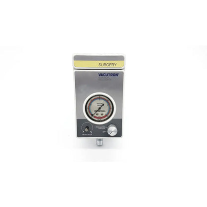 Silver-colored vacutrol health care surgical evacuator with circular gauge and two knobs labeled surgery on top yellow strip