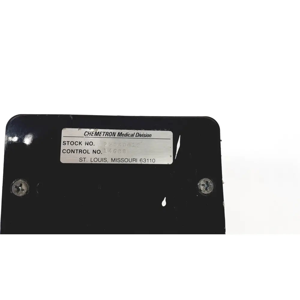 Black rectangular vacutrol health care medical casing with silver chemetron medical division label and control numbers