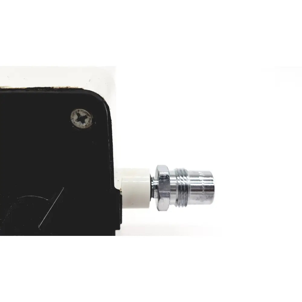 Chrome-finished threaded connector attached to white plastic fitting on black housing of vacutrol health care sugrical regu-gage