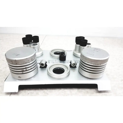 Silver metallic optical components with black rubberized eyepieces on white plate for vaisala hmk15 humidity calibrator