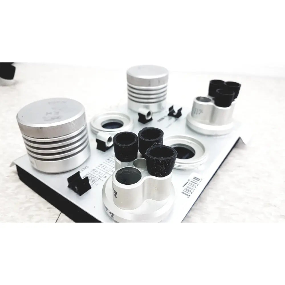 Silver and black cylindrical optical components on white tray of vaisala hmk15 humidity calibrator for probes and transmitters