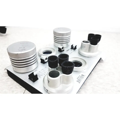 Silver and black cylindrical optical components on white tray of vaisala hmk15 humidity calibrator for probes and transmitters