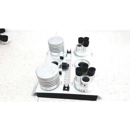 White laboratory-grade salt solution holder with black caps and silver rings in vaisala hmk15 humidity calibrator