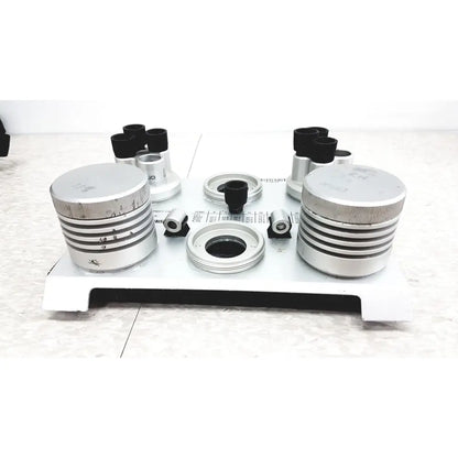 Silver metallic cylindrical components with ribbed texture and black-tipped optical attachments of vaisala hmk15 humidity calibrator