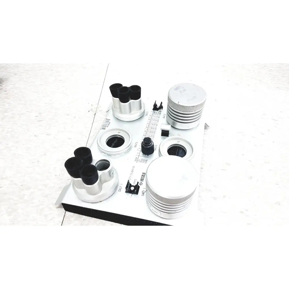 White and black vaisala hmk15 humidity calibrator with multiple lenses, adjustable knobs, and measurement scale for probes