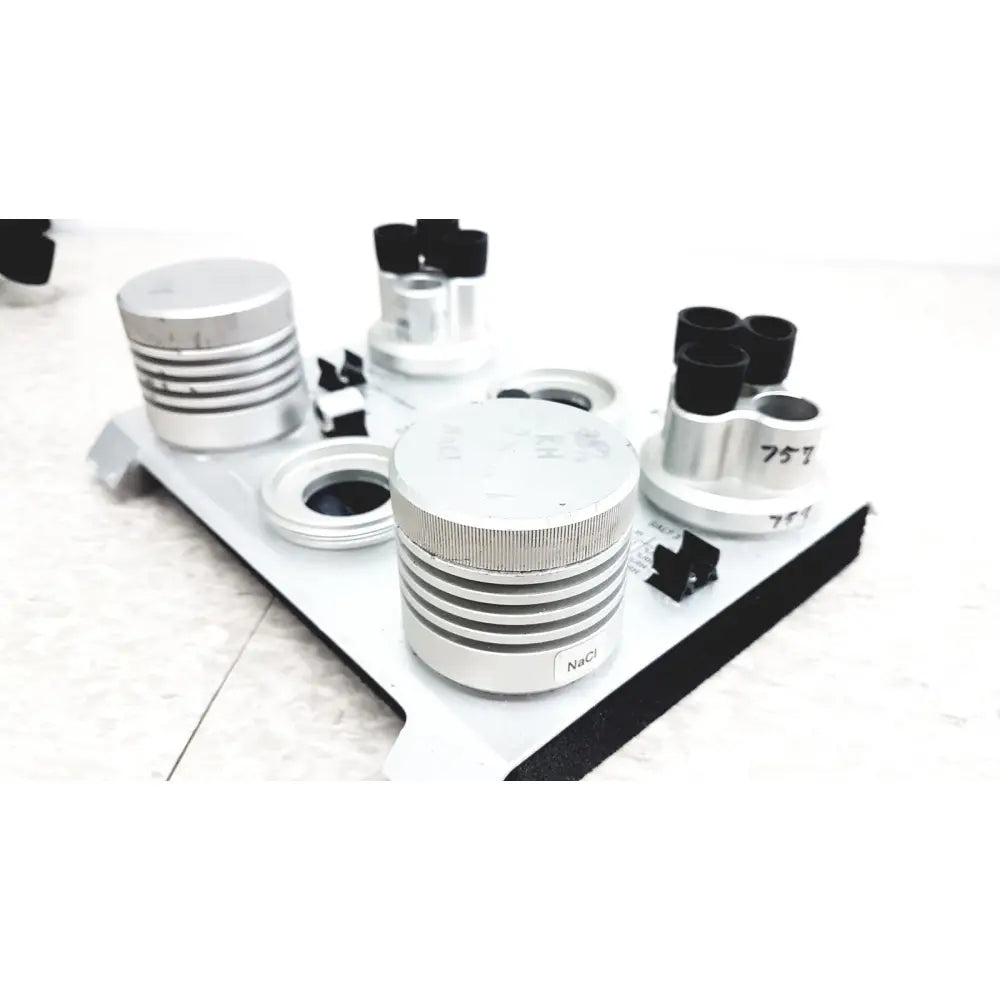 Silver cylindrical optical components with black caps and engravings on white tray for vaisala hmk15 humidity calibrator