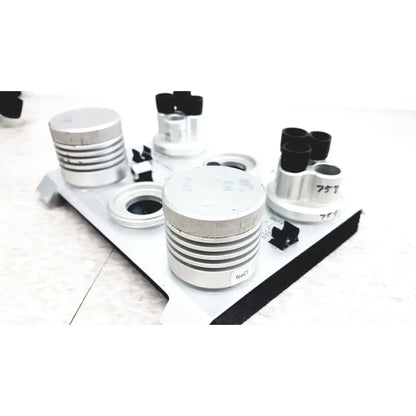 Silver cylindrical optical components with black caps and engravings on white tray for vaisala hmk15 humidity calibrator