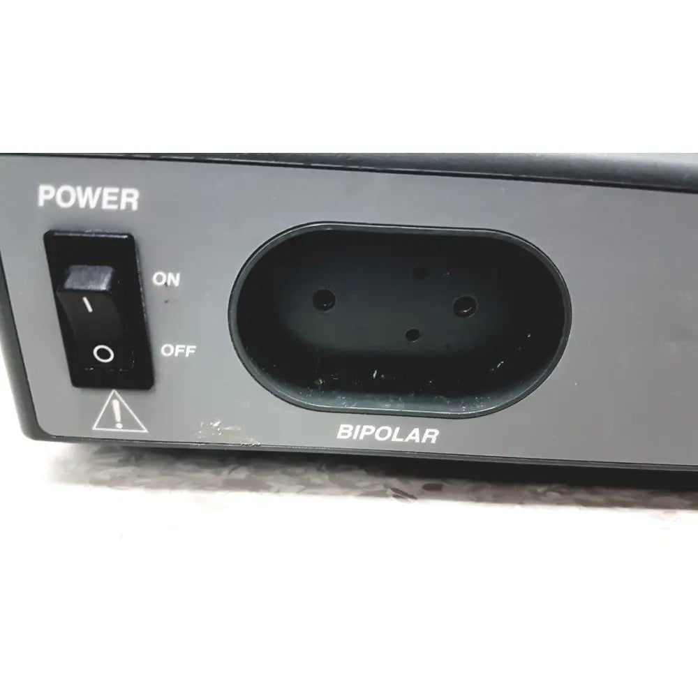 Back side of a black plastic power switch with on off and warning symbol on valleylab force electrosurgical unit foot pedal input port