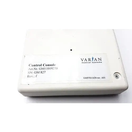 White plastic varian control console gm11019270 with label displaying varian medical systems and technical specifications