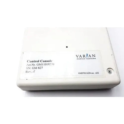 White plastic varian control console gm11019270 with label displaying varian medical systems and technical specifications