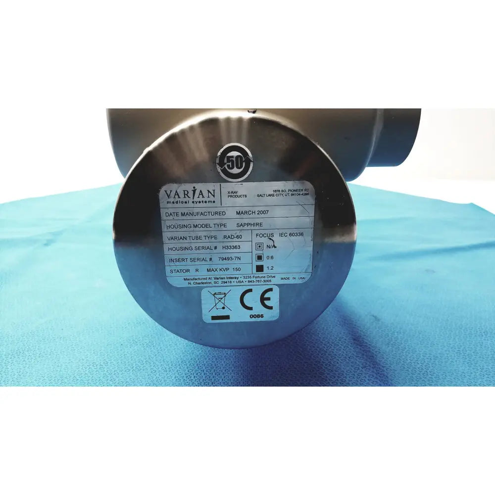 Silver metallic cylindrical varian rad-60 tube housing with engraved label for reuse medical parts or not working units