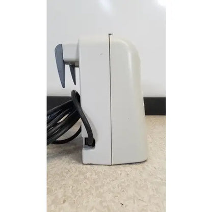 Off-white plastic electric toothbrush charger with black cord coiled for venaflow 120508 elite aircast dvt vascular pump system