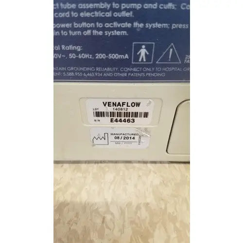 Beige plastic venaflow elite aircast dvt vascular pump system with barcode label and serial number visible on back side