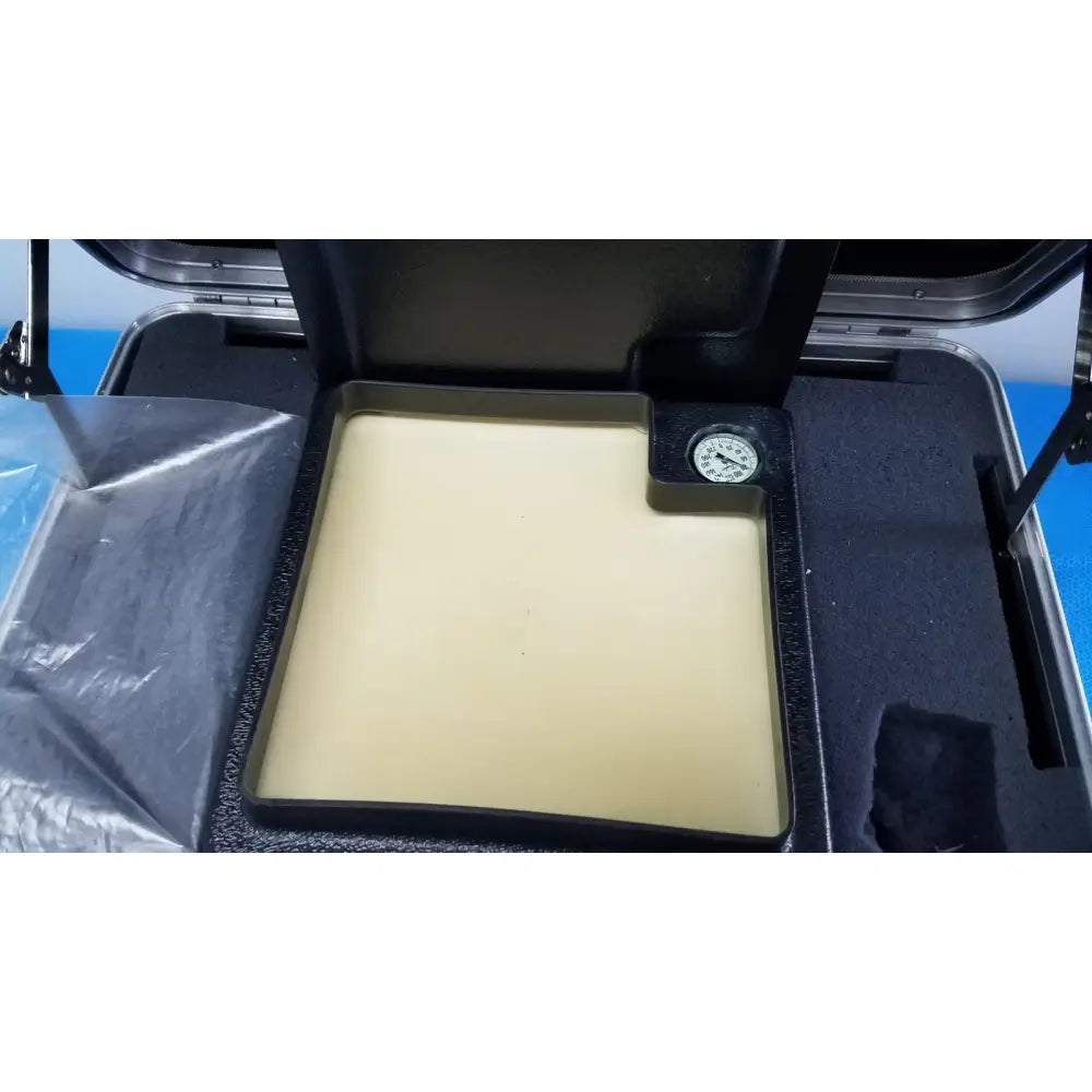 Beige rectangular verathon bladderscan tissue equivalent bladder phantom pressure plate with attached circular gauge