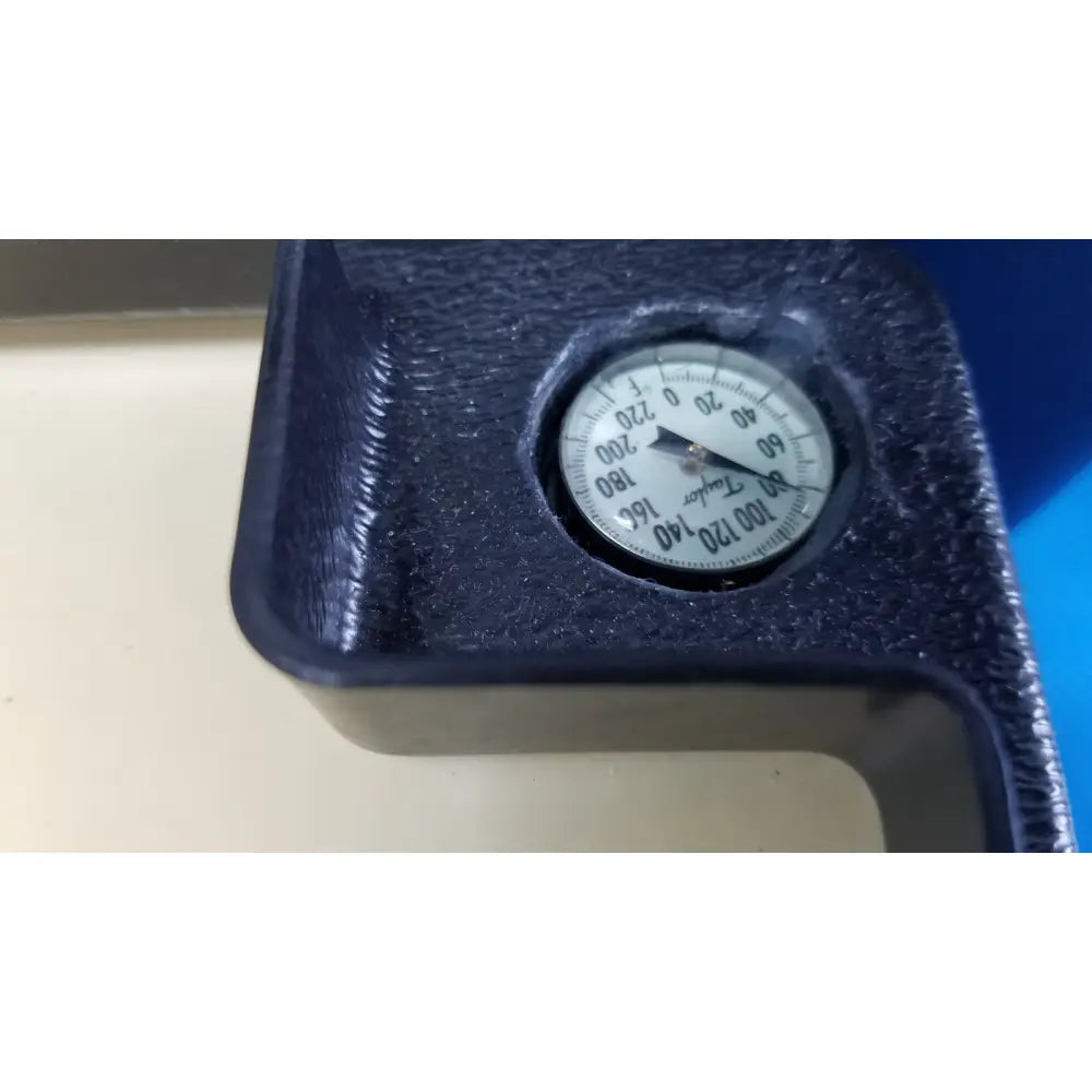 Black textured plastic housing with circular white dial pressure gauge on verathon bladderscan tissue equivalent bladder phantom