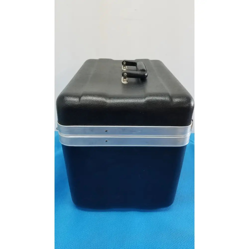 Black and navy blue two-tone hard-shell travel case with silver metal band and handle for Verathon BladderScan tissue equivalent bladder phantom