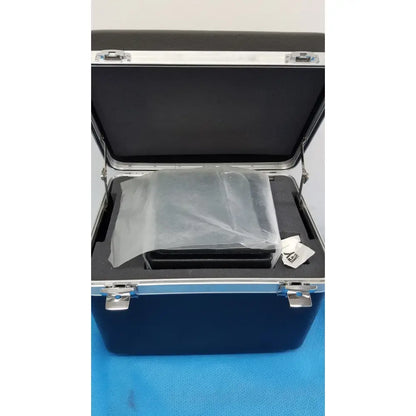Blue hard-shell carrying case with silver latches and black interior holding verathon bladderscan tissue equivalent bladder phantom device