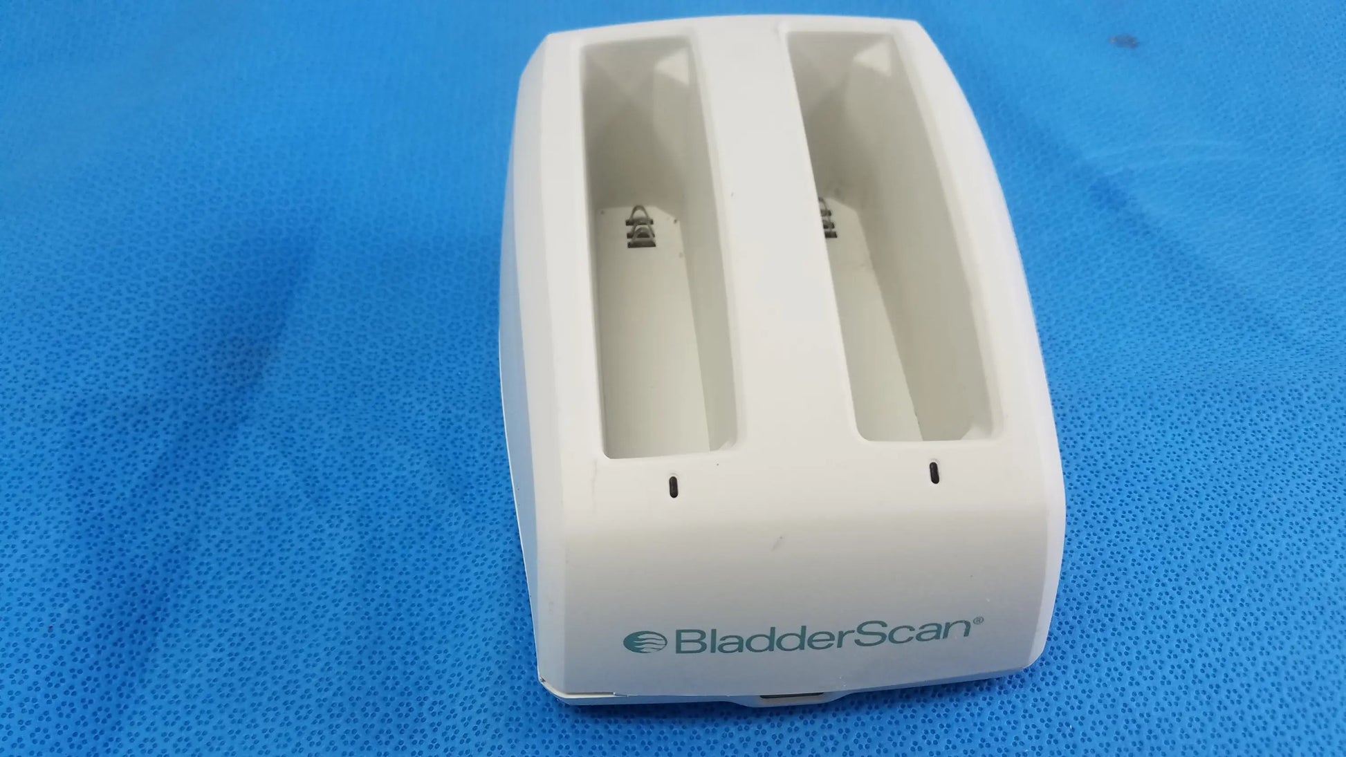 White plastic verathon bladderscan battery charger with two battery slots and logo compatible verathon bladderscan