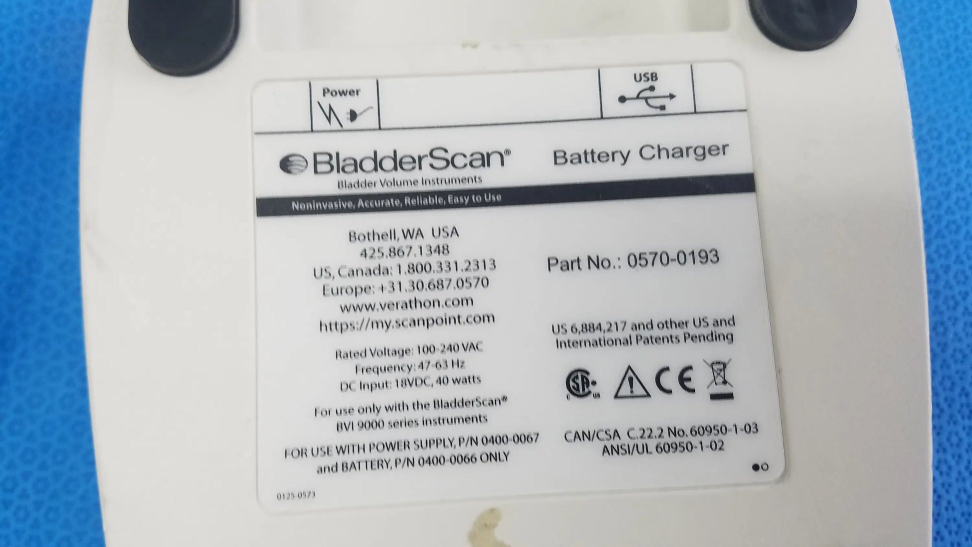 White plastic verathon bladderscan battery charger with black circular ports and label p n 0570-0193 compatible verathon bladderscan