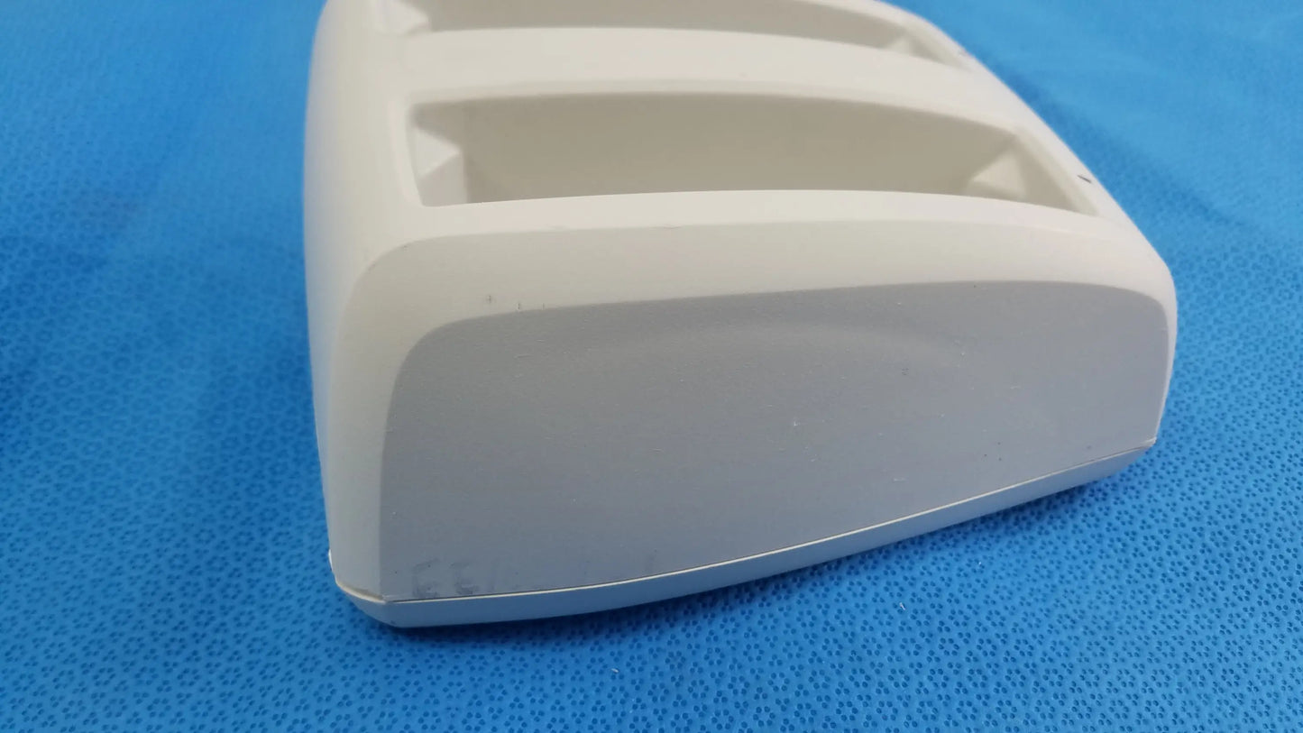White plastic toothbrush holder with three rectangular slots and rounded edges for compatible verathon bladderscan battery charger p/n 0570-0193