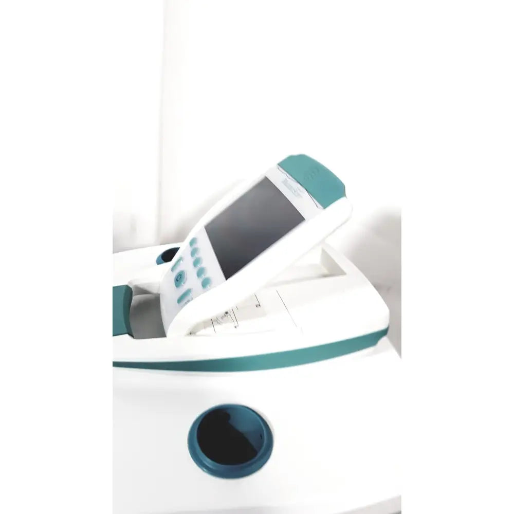 White and teal verathon bladderscan bvi 9600 bladder scanner with screen buttons circular opening on rolling stand