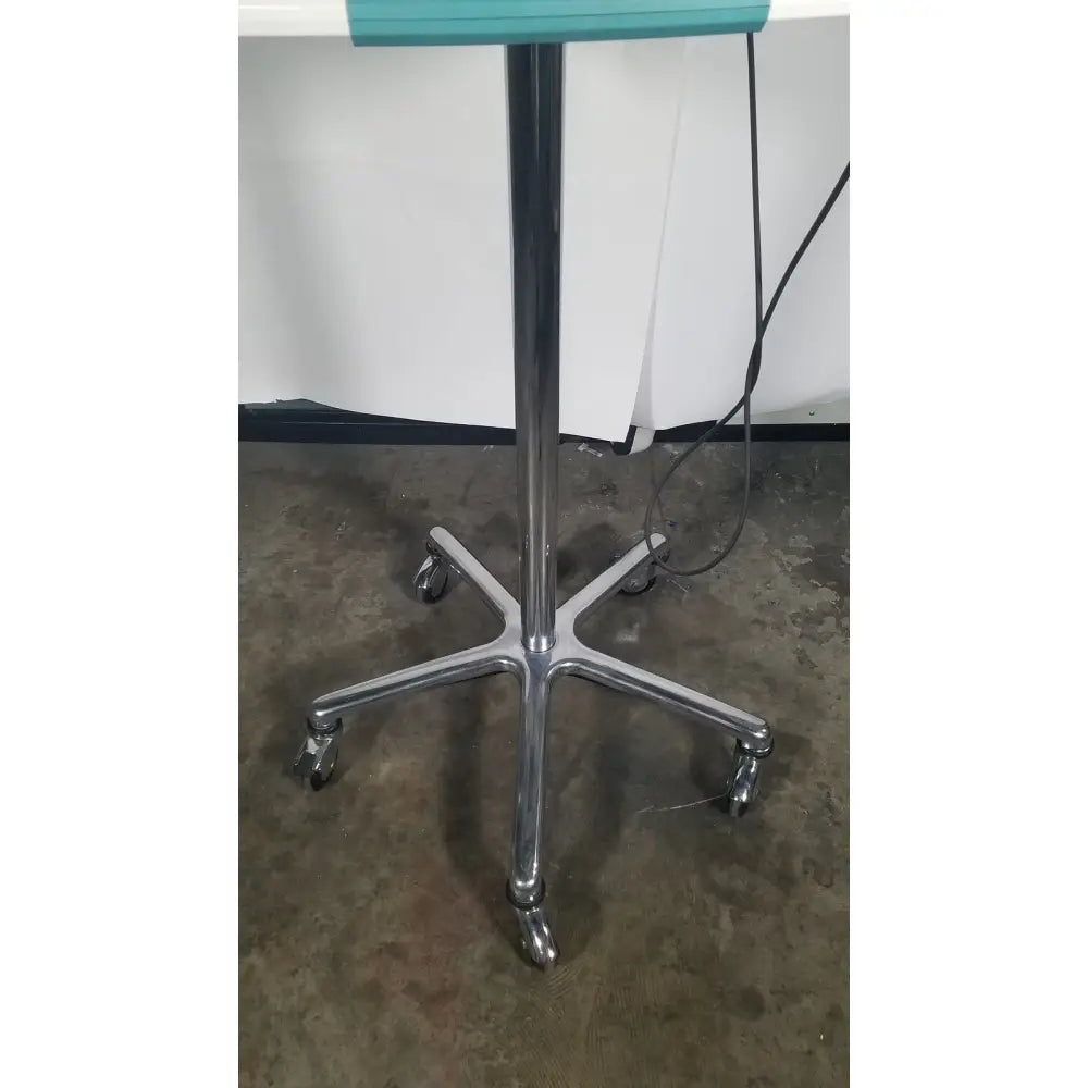 Verathon bladderscan stand with chrome-finished five-legged rolling base and teal top surface for reuse medical settings