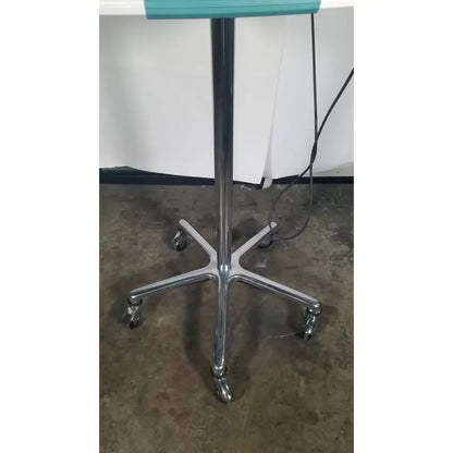 Verathon bladderscan stand with chrome-finished five-legged rolling base and teal top surface for reuse medical settings