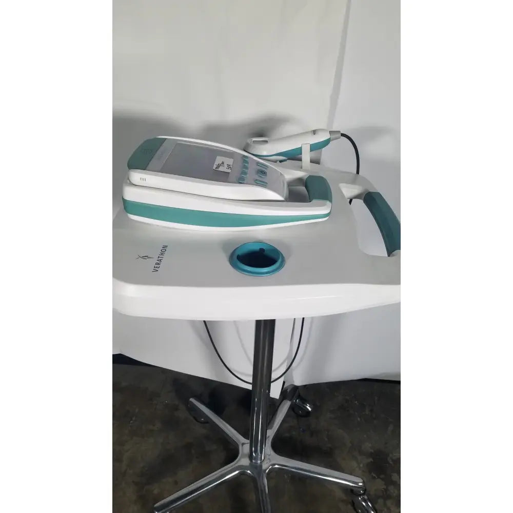 White and teal Verathon BladderScan stand medical device with handheld probe resting on its console for bladder assessment