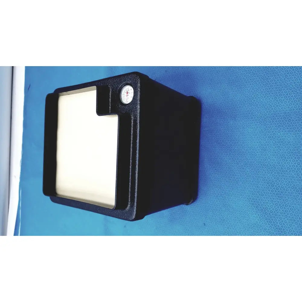 Black rectangular verathon bladderScan tissue equivalent bladder phantom with white panel and circular gauge on top right corner