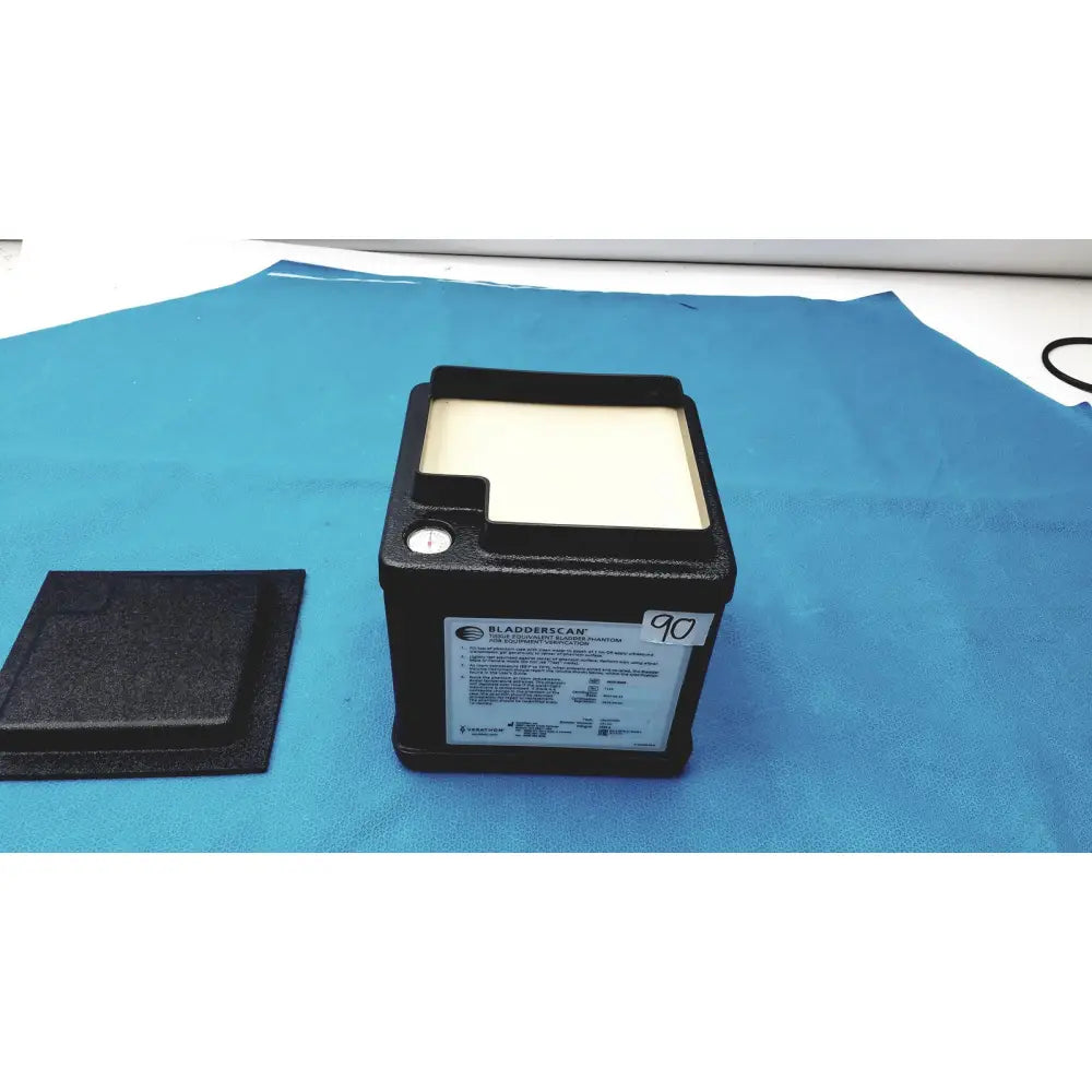 Black verathon bladderscan tissue equivalent bladder phantom with white display screen and matching black lid beside it