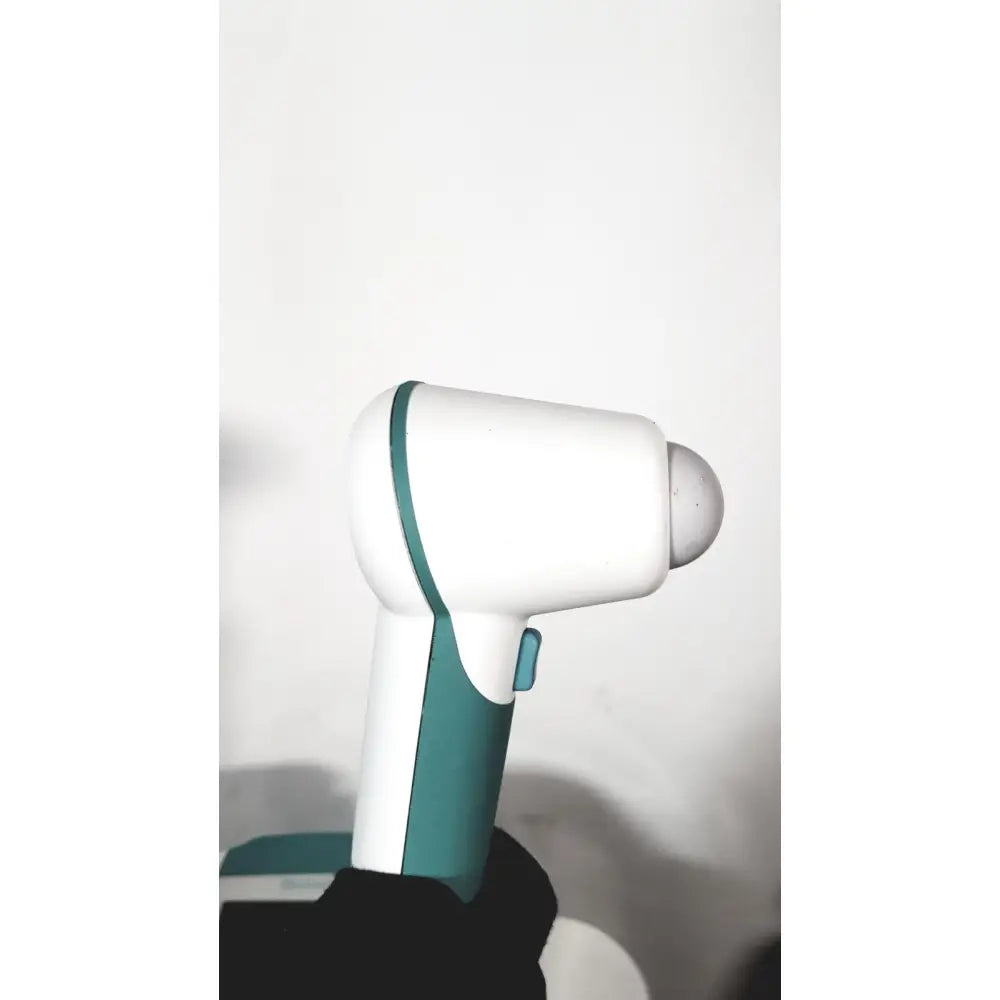 White and teal handheld massage gun with rounded tip alongside verathon bvi 9400 bladder scan ultrasound scanner