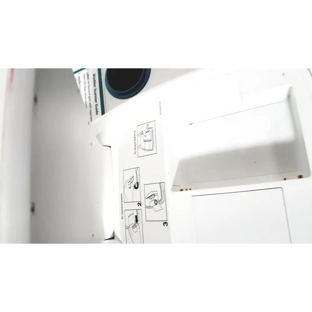 White plastic blade scanner guide with printed assembly instructions and blue circular component on verathon bvi bladder scan ultrasound scanner