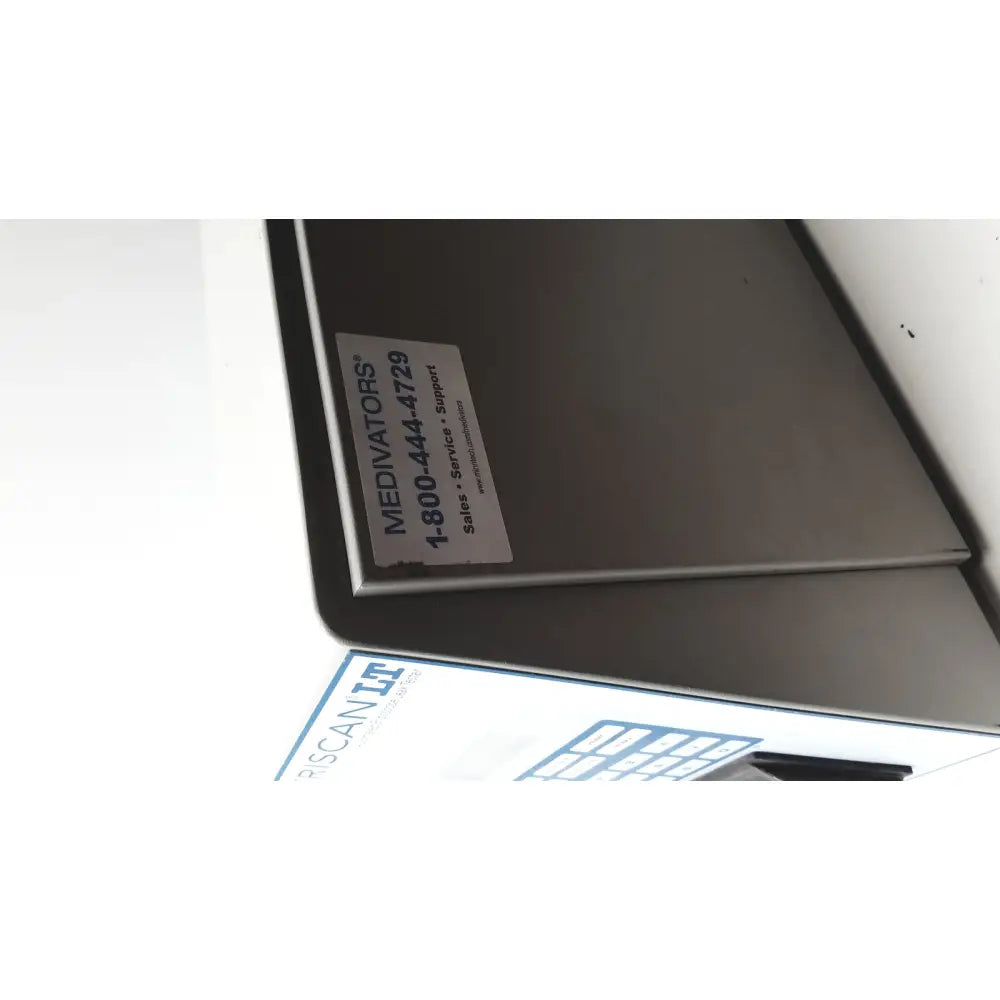 Silver metallic medivators veriscan lt automated endoscope leak tester box with white label showing contact information