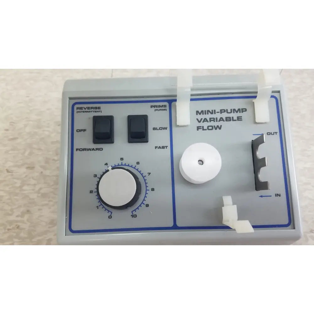 Gray plastic mini-pump variable flow device with black switches and white dial for verities analyzer clinical laboratory diagnostic use