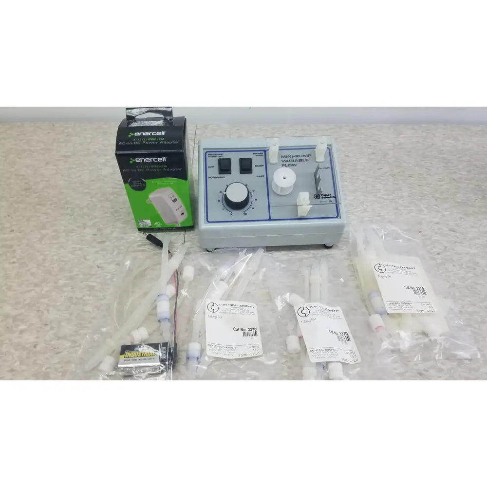 Light gray plastic mini-pump variable flow device with black knobs and white dials for verities analyzer clinical laboratory diagnostic system