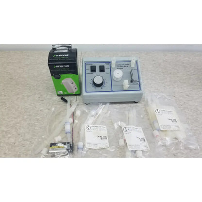 Light gray plastic mini-pump variable flow device with black knobs and white dials for verities analyzer clinical laboratory diagnostic system